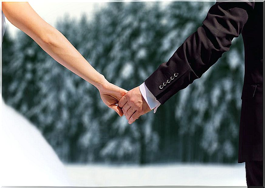Couple holding hands in winter.