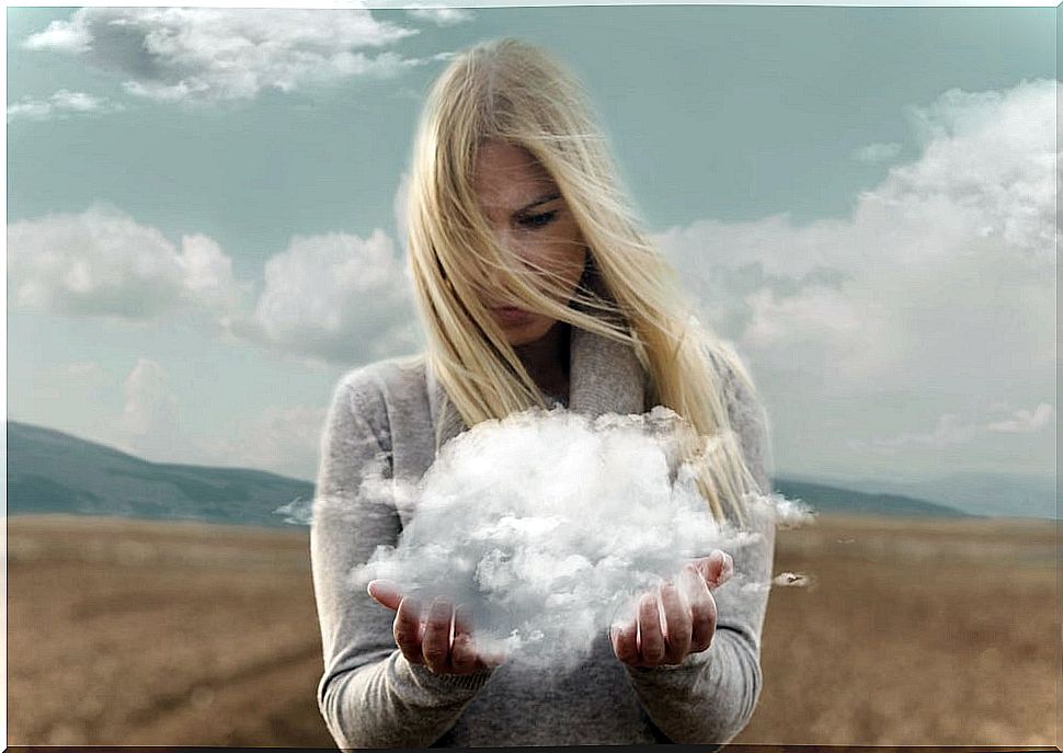 Woman looking at cloud between her hands