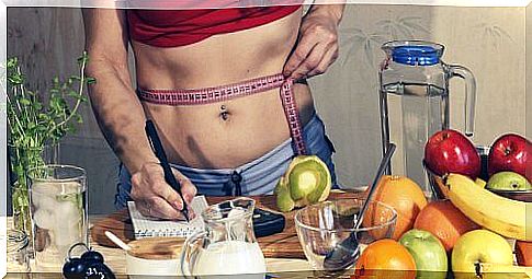 Weight loss products: measuring your abdomen and writing down in a notebook along with food