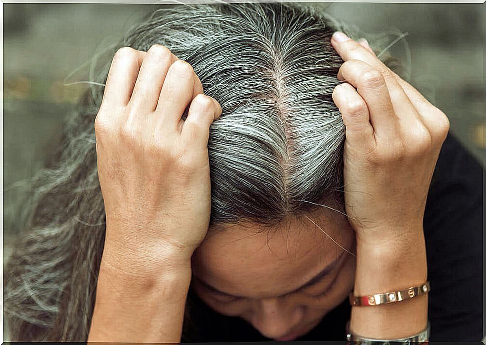 Woman showing gray roots.