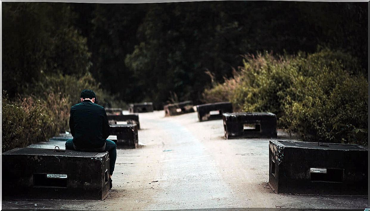 Sad and lonely man sitting on a bench.