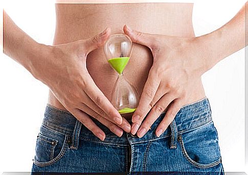 Woman holding an hourglass on her belly