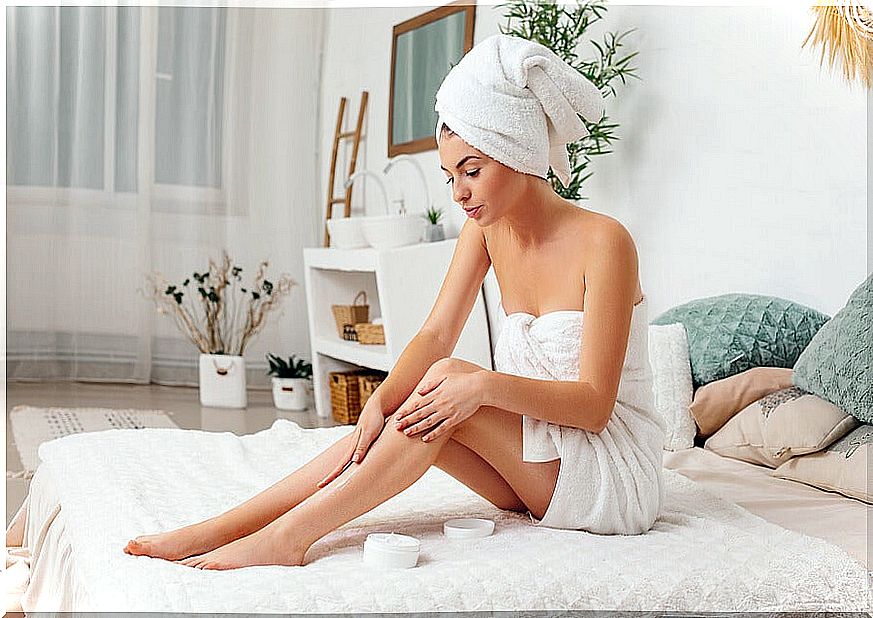 Woman applying cream to her legs
