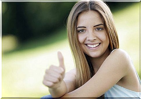 Happy girl with raised thumb