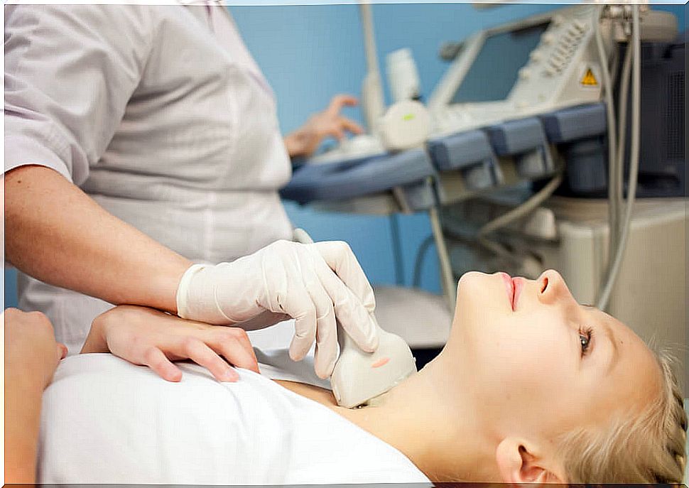 Woman undergoing thyroid ultrasound.